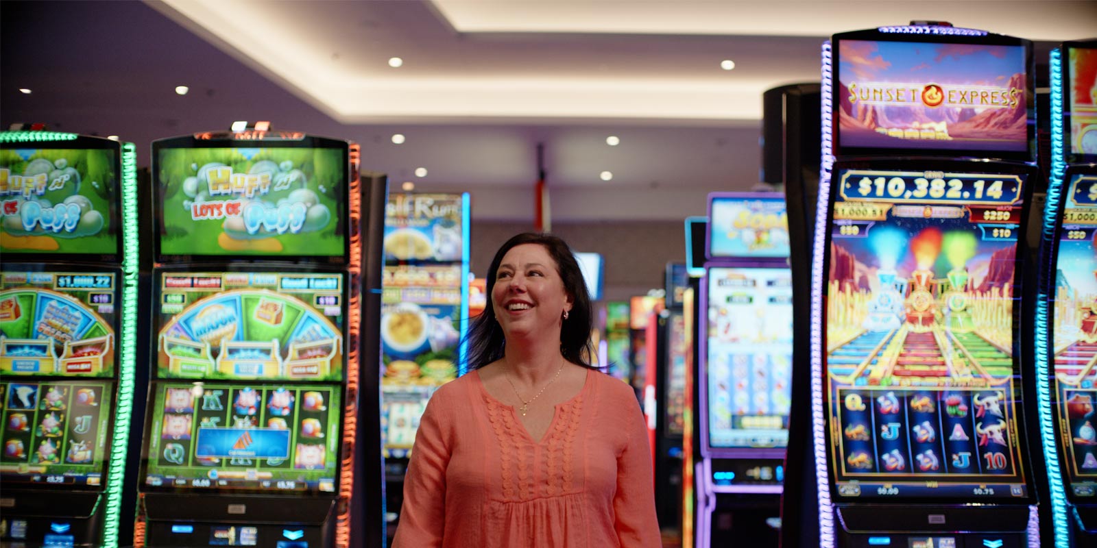 Customer smiling and looking around the casino at Two Kings