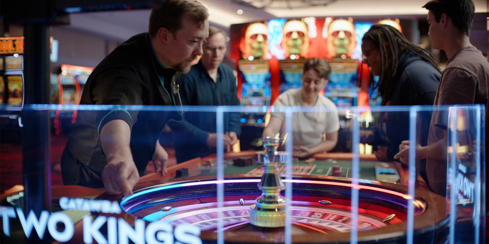 Two Kings Casino Employee dealing a game to customers